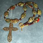 Item N10. Dragon Bloodstone ovals, strung with cranberry fresh water pearls, adorned by a bronze casting of an antique Celtic knot cross - 16" length plus 2" cross" - ($90 plus $5.20 S/H)