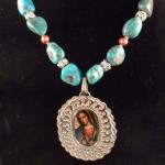 Item N13. Chunk turquoise strung with silver plated rose spacers and peach fresh water pearls adorned with oval nickel silver pendant frame - Our Lady of Guadalupe print- 18" length plus 2" pendant- ($125 plus $5.20 S/H)