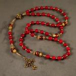 Red coral (6mm), Murano glass Paters with gold vermeil bead caps, accented with Swarovski crystals, gold plated pewter connector bead and Fleur de Lis cross. $60.00 plus $5.20 S/H.